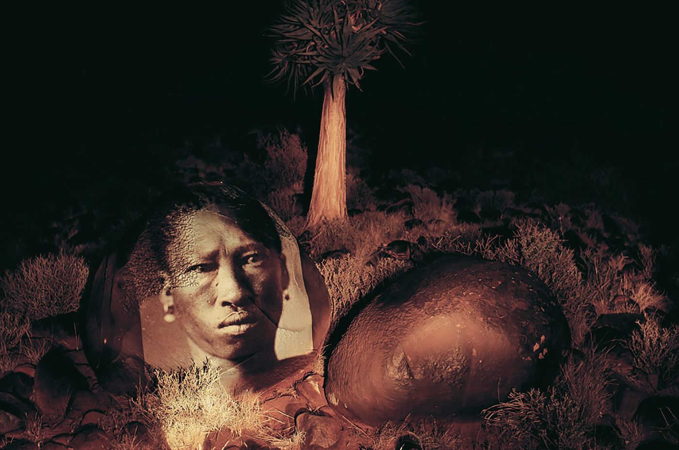 |hanǂkass’o face projected onto rock in his home territory south of the Bitterpits.