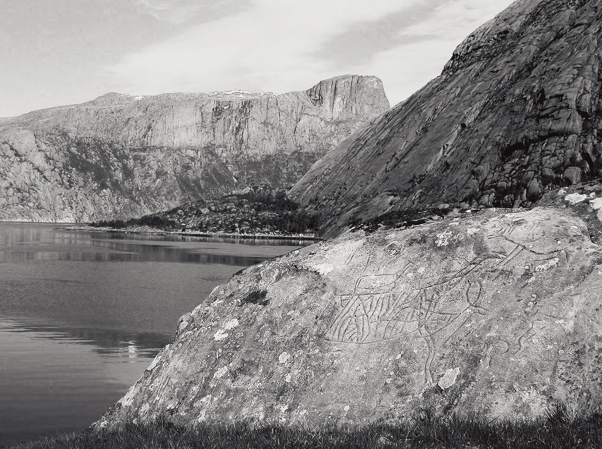 One of the most photographed motifs in Vingen, where Hornel towers over the landscape at the far back of the picture. The peak was climbed several times by Kristian Bing and about a thousand years earlier by Olav Trygvasson. In the middle Vingeneset where there are many carvings and further forward some of the motifs found on the mountain ridge Hardbakken Vingen Rock Art Carvings Norway